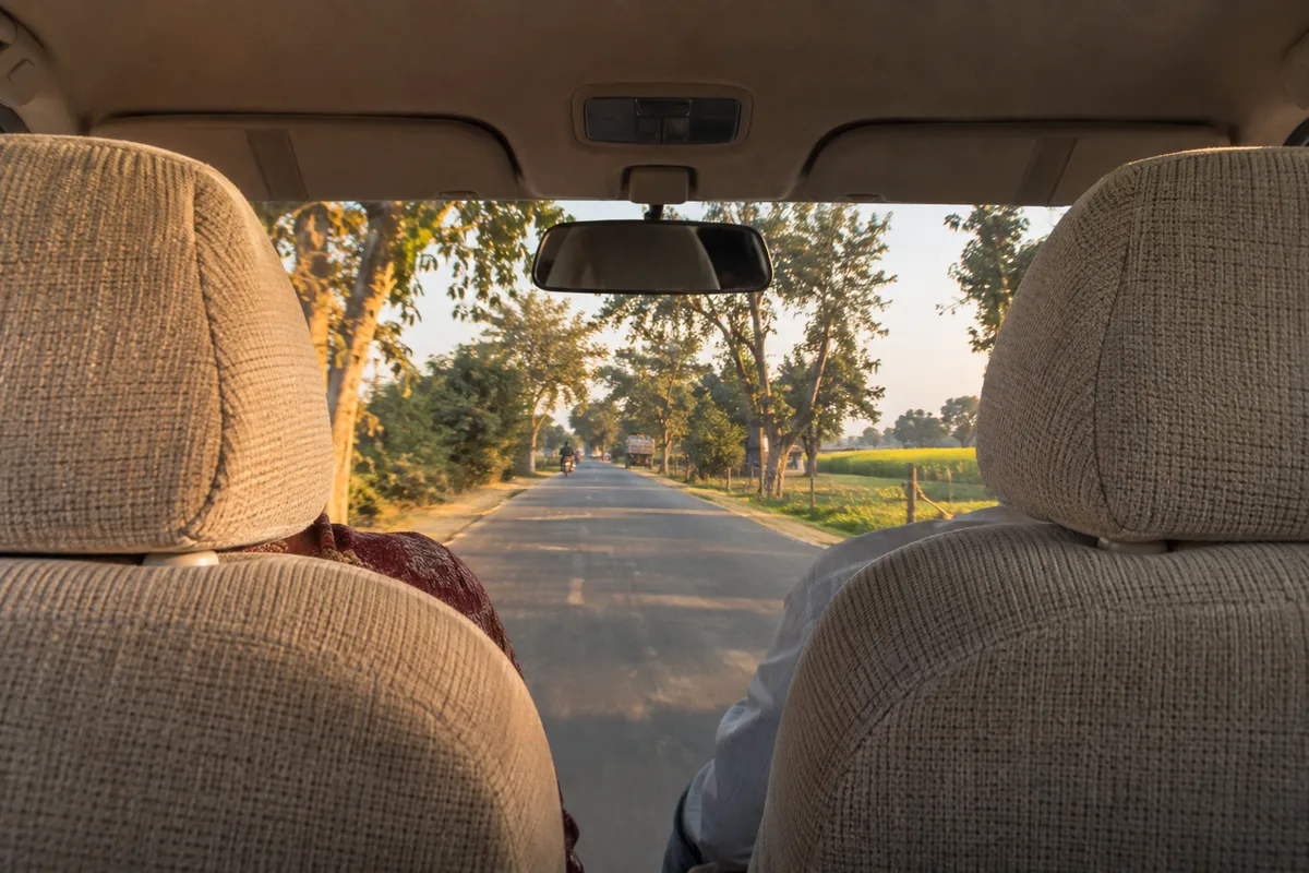 Route indienne vue depuis la place arrière d’une voiture, à travers le pare-brise